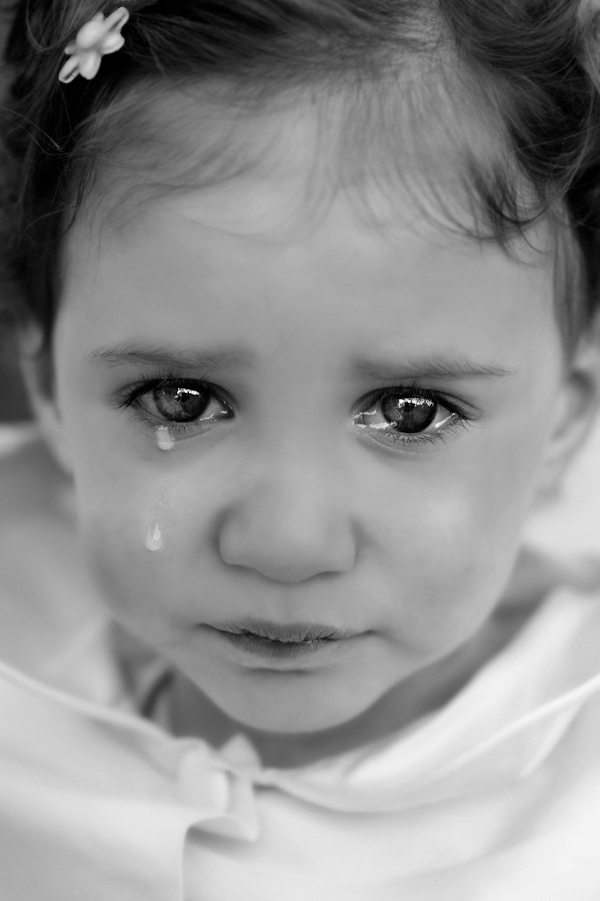 Sweet child with tears in her eyes - wedding photo by Jerry Ghionis